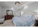Spacious main bedroom suite with a tray ceiling, ceiling fan, and dark wood dresser with mirror at 708 Mill Pointe Way, Elon, NC 27244