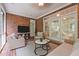This covered patio offers brick walls, white trim, tile floors, and comfortable wicker furniture at 708 Mill Pointe Way, Elon, NC 27244