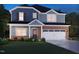 Charming two-story home featuring blue siding, brick accents, a two-car garage, and a well-manicured lawn at 729 Deschutes Dr, Garner, NC 27529