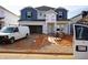 New home under construction with blue and gray siding, a two-car garage, and a covered front porch at 745 Deschutes Dr, Garner, NC 27529