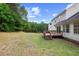 Home's backyard shows a wood deck and generous lawn space, ideal for relaxation and outdoor activities at 8004 Mill Bluff Ct, Raleigh, NC 27616