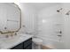 Bathroom featuring updated vanity, marble countertop, and tub with shower at 8004 Mill Bluff Ct, Raleigh, NC 27616