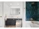Updated bathroom featuring modern vanity, marble countertop, and dark tile shower at 8004 Mill Bluff Ct, Raleigh, NC 27616
