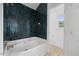 Updated bathroom with dark tile surround on soaking tub and separate toilet area at 8004 Mill Bluff Ct, Raleigh, NC 27616