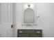 Stylish half bathroom with marble countertop, gold fixtures, and an elegant mirror at 8004 Mill Bluff Ct, Raleigh, NC 27616