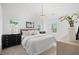 Bright, carpeted bedroom with many windows and a luxury ceiling light fixture at 8004 Mill Bluff Ct, Raleigh, NC 27616