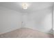 Bright, carpeted bedroom featuring a centered ceiling light and a door, with neutral décor at 8004 Mill Bluff Ct, Raleigh, NC 27616