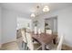 Elegant dining room with modern lighting fixture and a view to the living room at 8004 Mill Bluff Ct, Raleigh, NC 27616