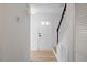Bright entryway featuring hardwood floors, white walls, and a staircase at 8004 Mill Bluff Ct, Raleigh, NC 27616