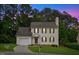 Charming two-story home featuring well-manicured lawn and attached garage, perfect curb appeal at 8004 Mill Bluff Ct, Raleigh, NC 27616