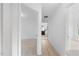 Bright hallway with hardwood floors offers access to several bedrooms at 8004 Mill Bluff Ct, Raleigh, NC 27616