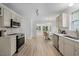 Modern kitchen with stainless steel appliances, granite countertops, and hardwood floors at 8004 Mill Bluff Ct, Raleigh, NC 27616