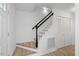 Stairway with dark banister, white risers and hardwood landing near the entry at 8004 Mill Bluff Ct, Raleigh, NC 27616