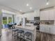 Modern kitchen with stainless steel appliances, white cabinets, and a spacious center island with seating at 805 Ottawa Dr, Garner, NC 27529