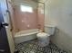 Bathroom with pink tile and black and white patterned floor at 829 Coleman St, Raleigh, NC 27610