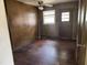 Bedroom with wood paneled walls and hardwood floors at 829 Coleman St, Raleigh, NC 27610
