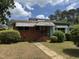 Charming one-story home with brick facade, awnings, and a small front yard at 829 Coleman St, Raleigh, NC 27610