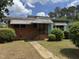 Charming one-story home with brick facade, awnings, and a small front yard at 829 Coleman St, Raleigh, NC 27610