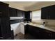Outdated kitchen with black cabinets and a yellow sink at 829 Coleman St, Raleigh, NC 27610