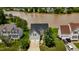 Aerial view of a charming home with a view of the lake and well-maintained landscaping at 1003 Southshore Pkwy, Durham, NC 27703
