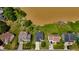 Aerial view of houses with lawns that border the waterfront and a pier, and a street out front at 1003 Southshore Pkwy, Durham, NC 27703