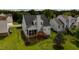 Aerial view of the property showcasing the backyard, deck, screened porch and surrounding greenery at 1003 Southshore Pkwy, Durham, NC 27703