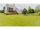 Expansive backyard with green lawn and deck, perfect for outdoor activities and enjoyment at 1003 Southshore Pkwy, Durham, NC 27703