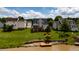 The backyard has a deck, landscaping, green grass leading up to the waterfront where there is a pier at 1003 Southshore Pkwy, Durham, NC 27703