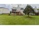 Spacious backyard featuring a deck, well-maintained lawn, and mature landscaping at 1003 Southshore Pkwy, Durham, NC 27703