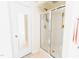 Bright bathroom featuring a glass enclosed shower and a door with a mirror at 1003 Southshore Pkwy, Durham, NC 27703