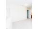Carpeted loft area features white trim and neutral walls with a door frame at 1003 Southshore Pkwy, Durham, NC 27703