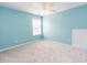 Bright bedroom with neutral carpeting, light blue walls, and a window at 1003 Southshore Pkwy, Durham, NC 27703