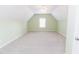 Spacious bedroom with neutral carpet, a ceiling fan, light green walls and a window providing natural light at 1003 Southshore Pkwy, Durham, NC 27703