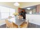 View of the dining area showcasing a table and chairs with natural lighting at 1003 Southshore Pkwy, Durham, NC 27703