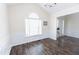 Dining room featuring hardwood floors, wainscoting, chandelier, and a large window at 1003 Southshore Pkwy, Durham, NC 27703