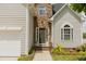 Charming home entrance with stone accents, a dark-colored front door, and well-manicured landscaping at 1003 Southshore Pkwy, Durham, NC 27703