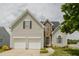 Charming home with a two-car garage, stone accents, a manicured lawn, and beautiful landscaping at 1003 Southshore Pkwy, Durham, NC 27703