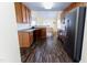 Spacious kitchen featuring stainless steel refrigerator, wood cabinets, and dark brown flooring at 1003 Southshore Pkwy, Durham, NC 27703