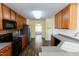 Open kitchen layout with modern appliances and a view of the entryway at 1003 Southshore Pkwy, Durham, NC 27703