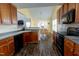 Well-lit kitchen with stainless steel appliances and wood cabinets overlooking the dining area at 1003 Southshore Pkwy, Durham, NC 27703