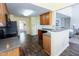 Open kitchen design with wood cabinets and stainless steel refrigerator at 1003 Southshore Pkwy, Durham, NC 27703