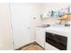 Well-organized laundry room with a modern washer and dryer, storage shelves, and a clean, functional layout at 1003 Southshore Pkwy, Durham, NC 27703
