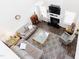 Aerial view of the living room featuring stylish furnishings, a cozy fireplace, and seamless transition to other areas at 1003 Southshore Pkwy, Durham, NC 27703