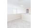 Neutral carpeted loft area with bright natural light and a white door frame at 1003 Southshore Pkwy, Durham, NC 27703