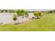 The backyard slopes to the waterfront where there is a pier and seating to enjoy the water at 1003 Southshore Pkwy, Durham, NC 27703