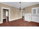 Open dining space with wood-look floors, classic chandelier, and a decorative fireplace with built-in shelving at 1007 Grace Ave, Burlington, NC 27217