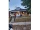 Charming single-story home featuring a peaked roof, decorative dormer, and inviting front porch with ramp access at 1007 Grace Ave, Burlington, NC 27217