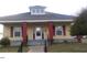 Inviting single-story home showcases a classic yellow exterior, complemented by red support columns, and a quaint dormer at 1007 Grace Ave, Burlington, NC 27217