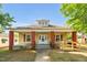 Charming single-story home featuring a welcoming front porch, vibrant red columns, and a convenient wheelchair ramp at 1007 Grace Ave, Burlington, NC 27217