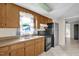 Functional kitchen featuring wood cabinets, stainless steel appliances, double sink, and a view of the backyard at 1007 Grace Ave, Burlington, NC 27217